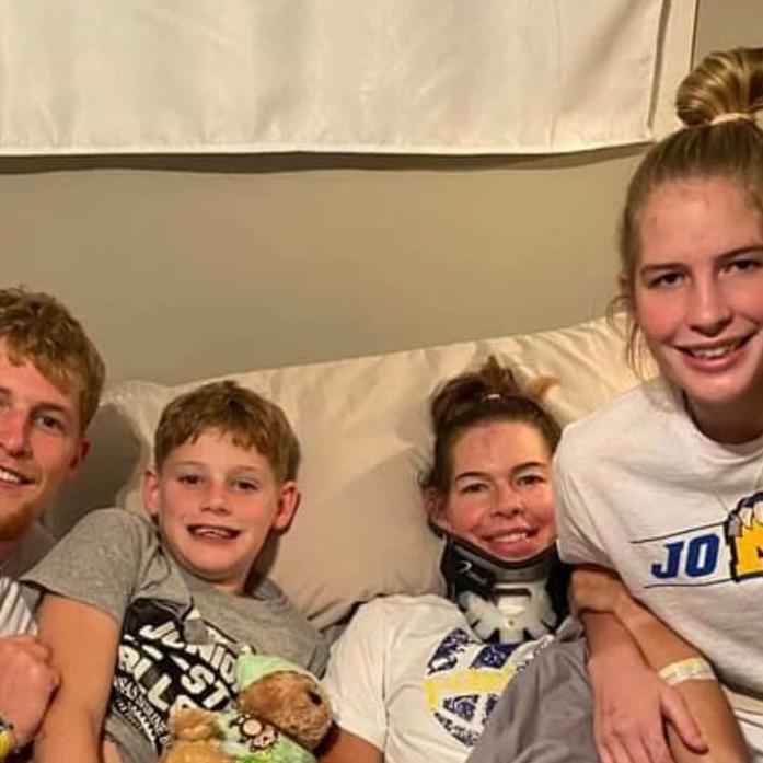 Hunter, Creek, Amy and Ava Jones smile for picture back in their KS home